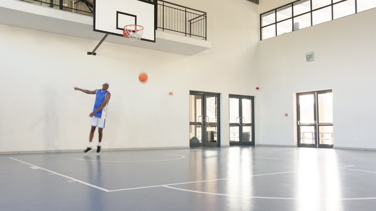 Practicing dribbling skills, athlete focused and determined on basketball court