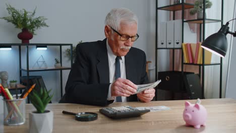 hombre de oficina de negocios senior contable o banquero usando calculadora haciendo dinero cálculos de efectivo