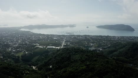 establishing shot of the sea and the island with the mountains in the background