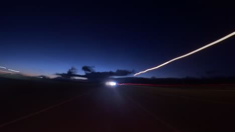 Abstract-light-trails-and-flashes-made-from-long-exposure-time-lapse-from-the-perspective-of-the-rear-window-of-a-car-while-driving
