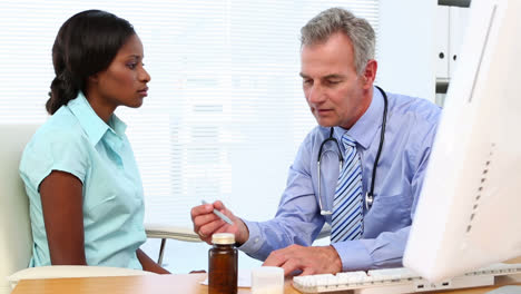 doctor speaking with his patient at desk