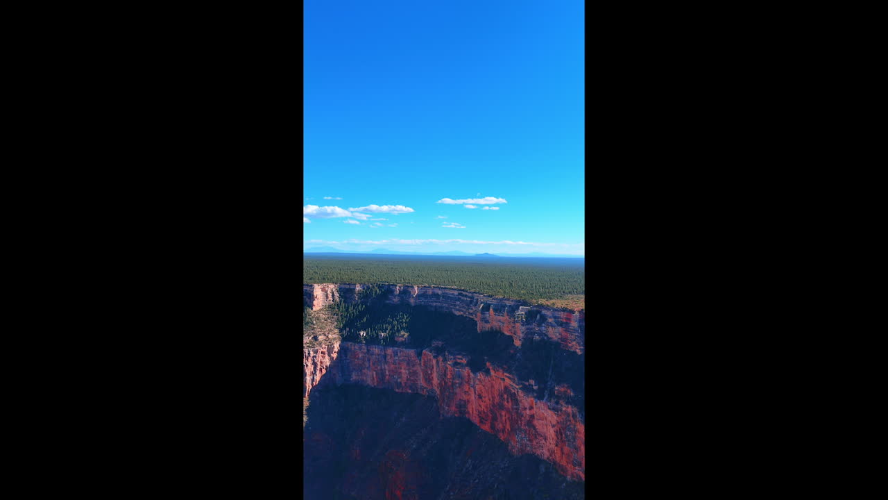 Steep rocks covered with plants. Greenery grows on top of the canyons on the plain. The Grand Canyon National Park, Arizona, USA. Vertical video