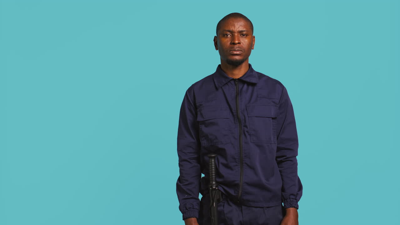 Portrait of intimidating security guard in uniform crossing arms