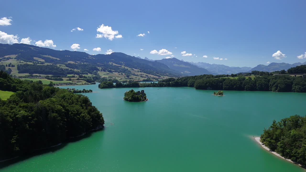 Artificial man-made turquoise blue water Greyerzersee Lake Gruyère Switzerland aerial drone