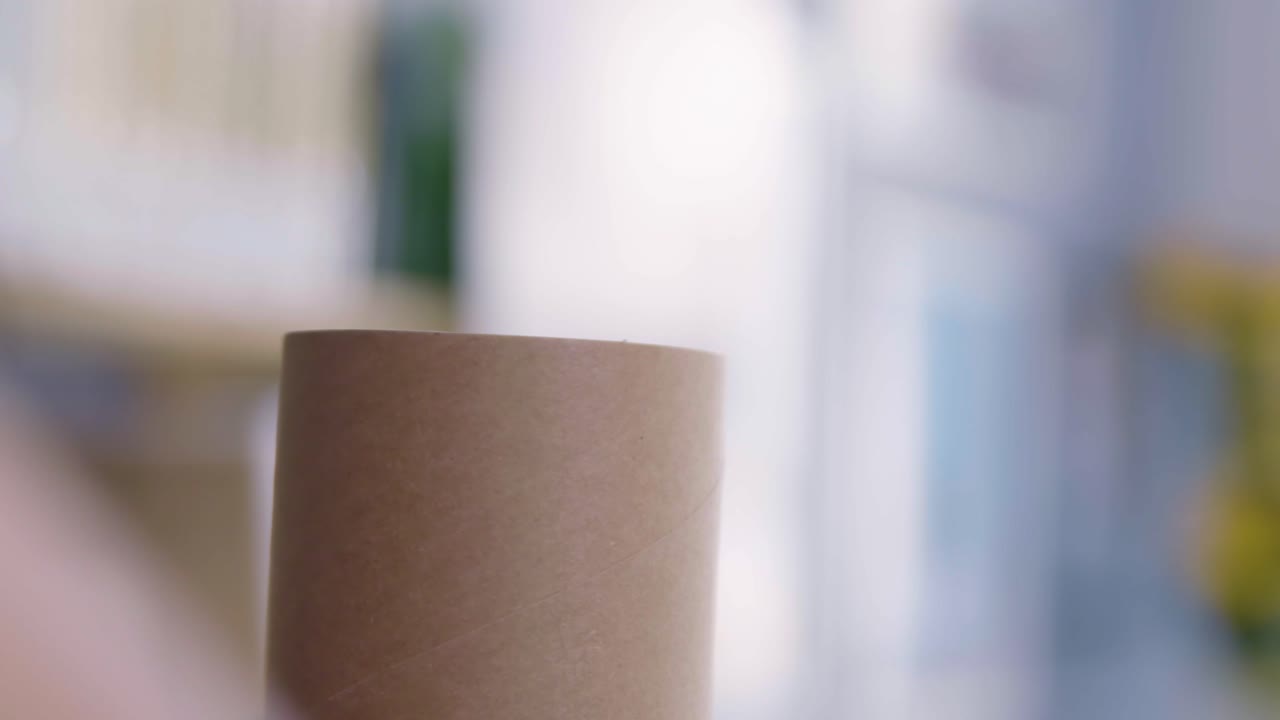 emale hands closeing plastick lead on the paper gray round tube for delivery or gif on the office desk