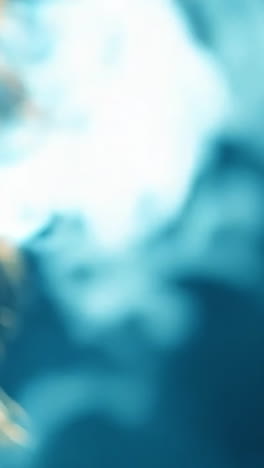 man exhaling smoke in a dim environment. a man breathes out a thick cloud of smoke in a softly lit space, creating an ethereal atmosphere.
