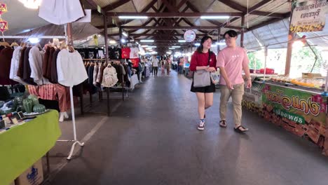 people walking through a vibrant indoor market