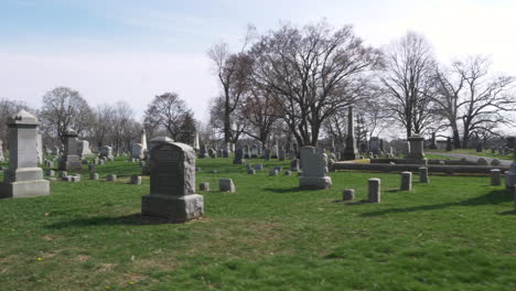 slow motion : driving slowly by rows of old headstones through a cemetery on a beautiful day