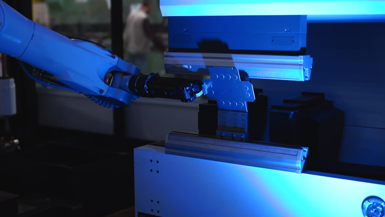 Robotic cnc arm moving a sheet of metal and doing two bends