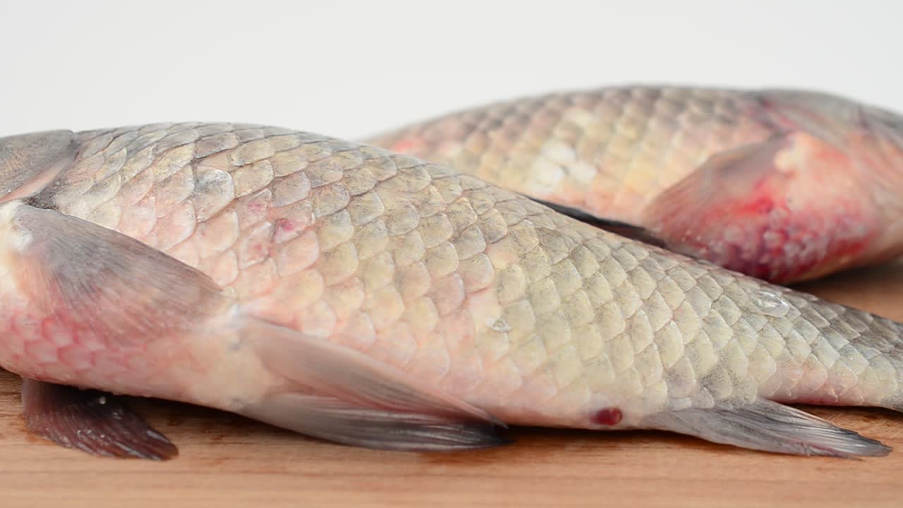 Crucians on a chopping board. Fresh fish