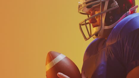 video of close up of caucasian american football player in helmet with ball over orange background