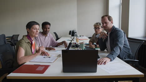diverse business team collaborating and discussing ideas in an office meeting