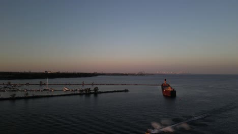 Forward-shot-of-an-abundant-ship-and-the-lake-during-sunset-with-a-jetski-coming-by