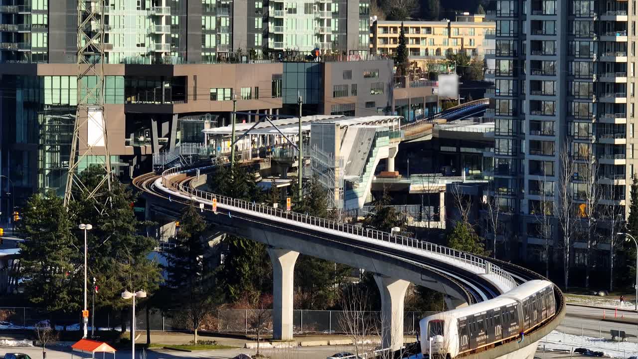 SkyTrain Going To Gilmore Station In Daytime In North Burnaby, Canada. - aerial shot