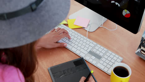 Female-graphic-designer-working-at-desk-4k