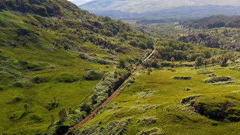 revealing drone shot of train in the glenfinnan viaduct