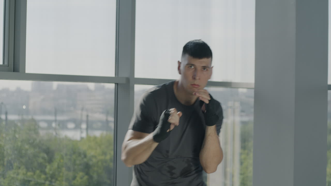 Man practicing boxing in a modern gym