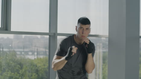 man practicing boxing in a modern gym