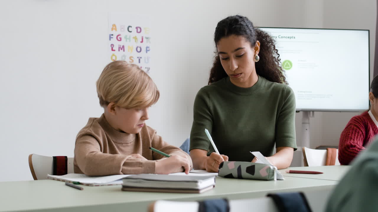 Teacher assisting student in classroom