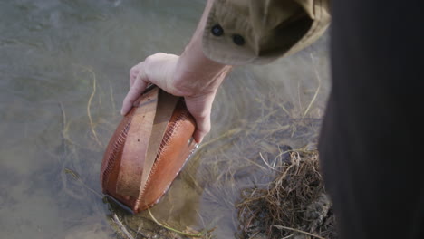 cowboy filling up his canteen