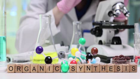 organic synthesis in a chemistry lab with a scientist and molecular model