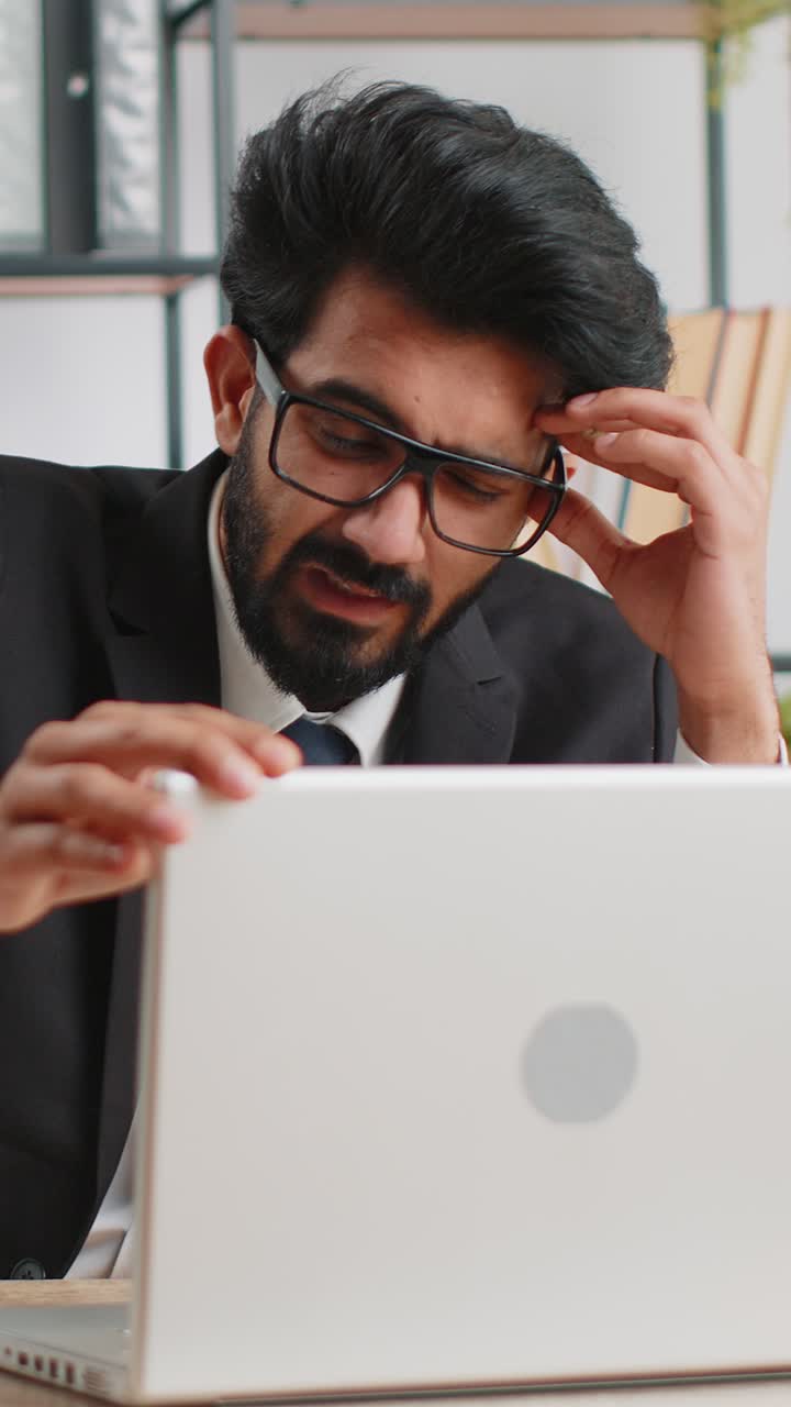 Irritated tired businessman working on laptop website problem computer virus data loss by hacking