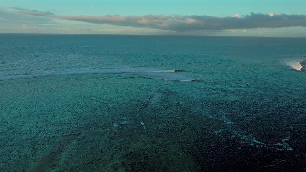 Haapoti Passe Coral Reef surfing wave boats in channel Moorea French Polynesia aerial drone morning sunrise lagoon South Pacific Ocean Tahiti Bora Bora forward pan up motion