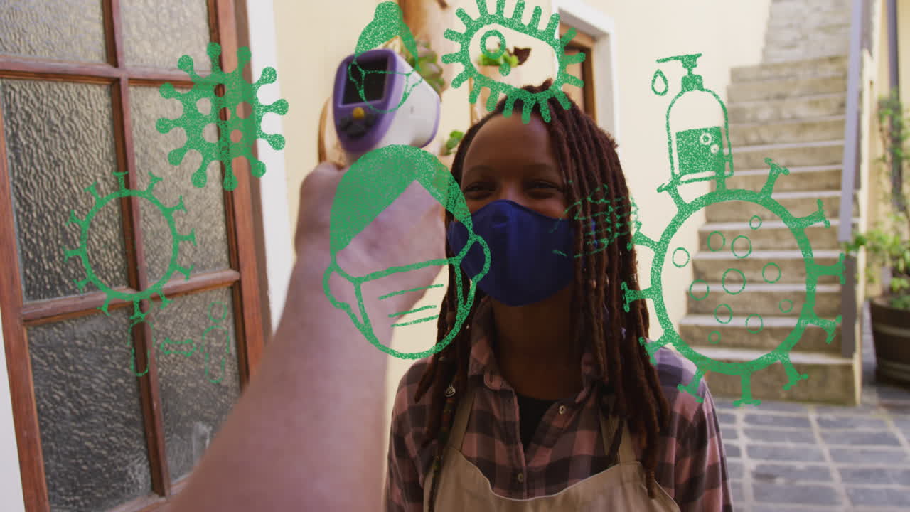 animación de iconos de virus sobre una mujer afroamericana con máscara facial tomando la temperatura