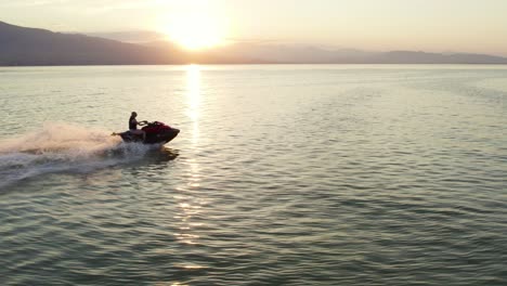 woman riding extreme sports waverunner sea doo jet ski on utah lake, aerial