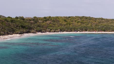 scenic half moon bay beach in antigua with turquoise water, white sand, and lush greenery