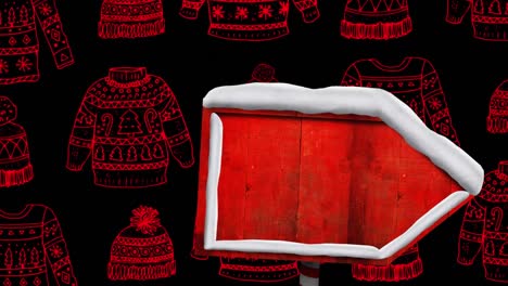 Animation-of-christmas-arrow-over-black-background-with-sweaters