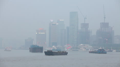 barges travel on the pearl river in shanghai china on a hazy day 2