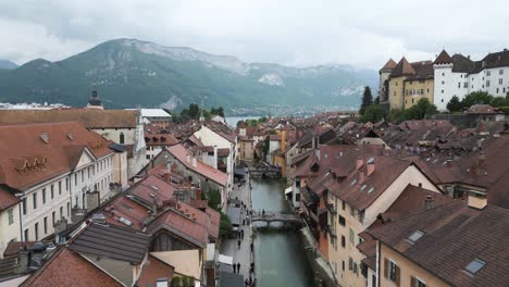 annecy, france canal river in old town city buildings, wide cinematic aerial landscape