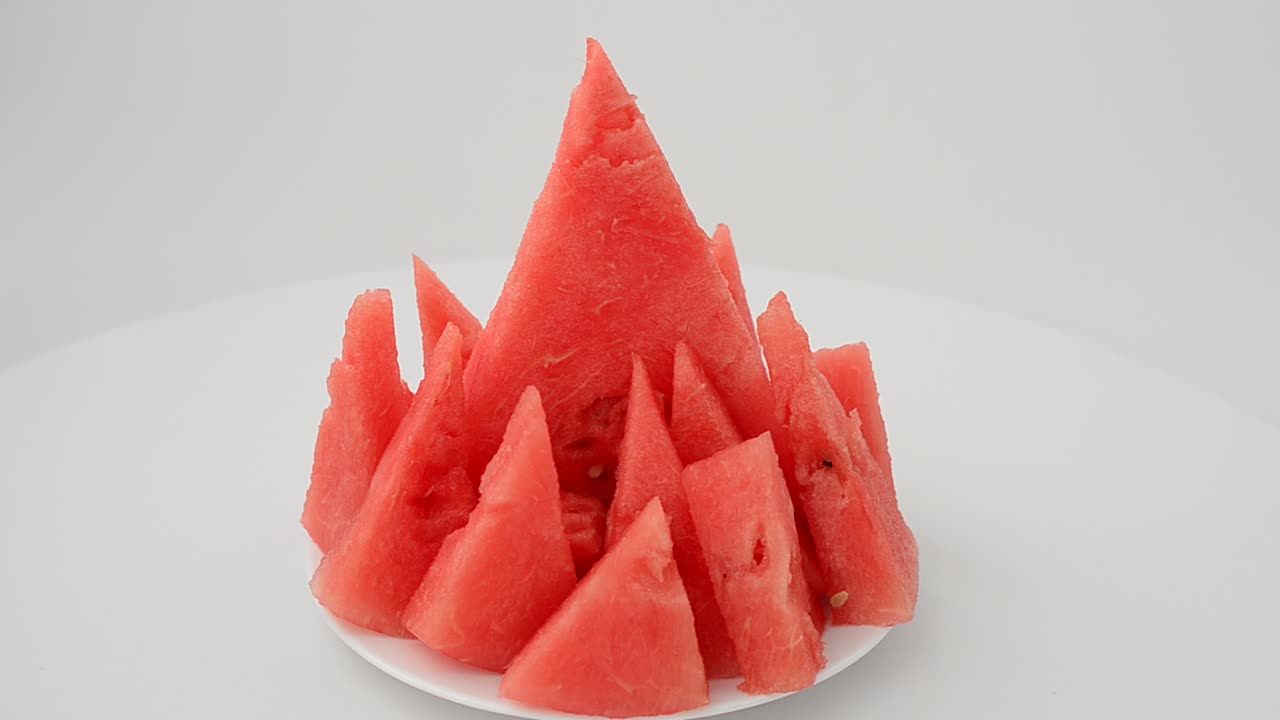 Shooting of a watermelon on a white background. Shooting in the movement