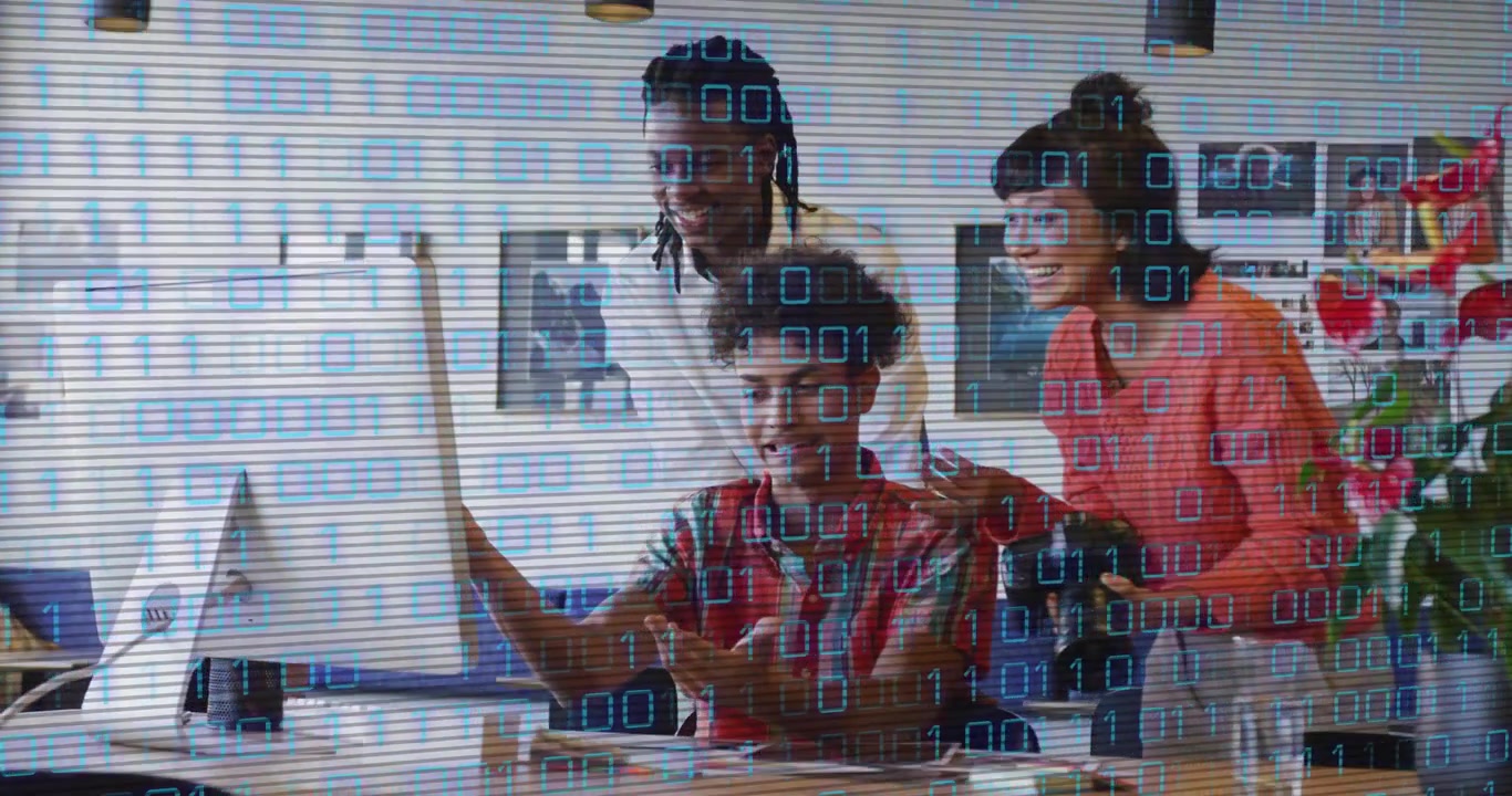 Seated operator pointing at monitor, using mouse, team confirming, binary overlay showing tech data