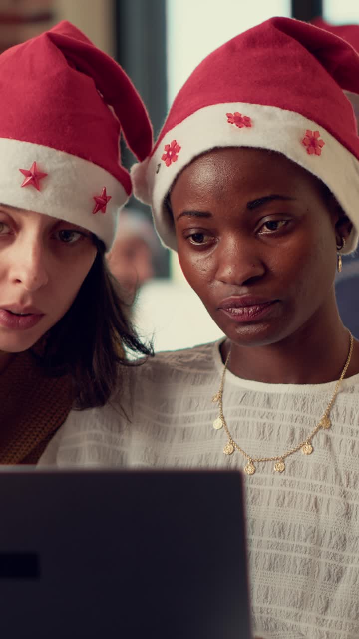 Women in Christmas Hats Using Laptop