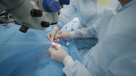 surgery team making strabismus surgery using modern technologies, latest devices, microscope in modern clinic