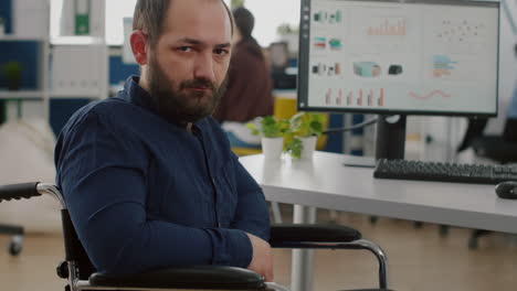 Young-man-with-disabilities-looking-at-camera-upset