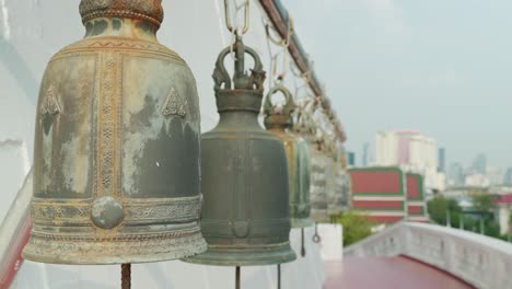 4K-Cinematic-slow-motion-footage-of-big-temple-buddhist-bells-at-Wat-Saket,-the-Golden-Mount,-Bangkok-during-a-sunny-day