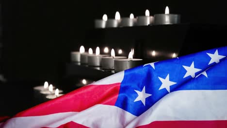 american flag and candles being blown