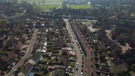 4k aerial view of a residencial area in taunton somerset, united kingdom, drone moving forward and showing the buildings roofs and street