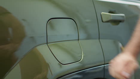 closeup of driver preparing to leave parking lot after recharging ev car