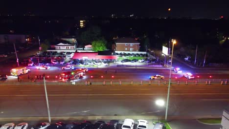 emergency response at night: police and firefighters at accident scene