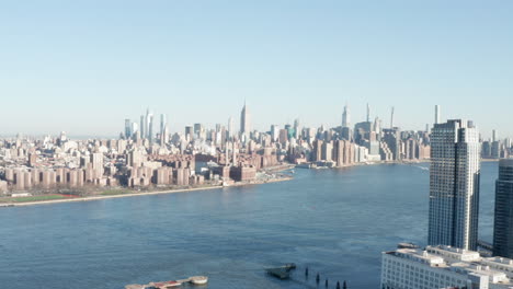 nyc skyline with empire state building slow pan left fancy condos in foreground neutral cc