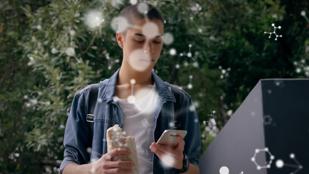 Man on balcony holding sandwich scrolling smartphone showing health molecular graphics floating