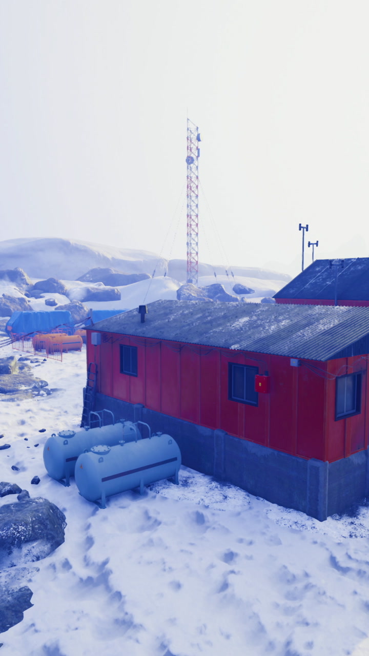 Research facility surrounded by snow covered mountains in a remote area