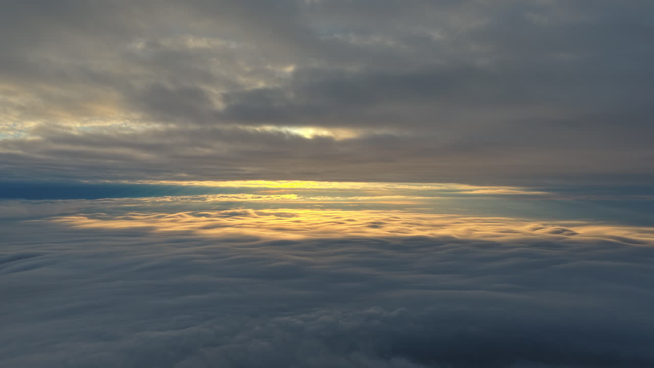 Vista panoramica aerea con drone di un'alba dorata sopra le nuvole, paesaggio invernale sulle montagne. Transilvania, Monte Ciucaș in Romania