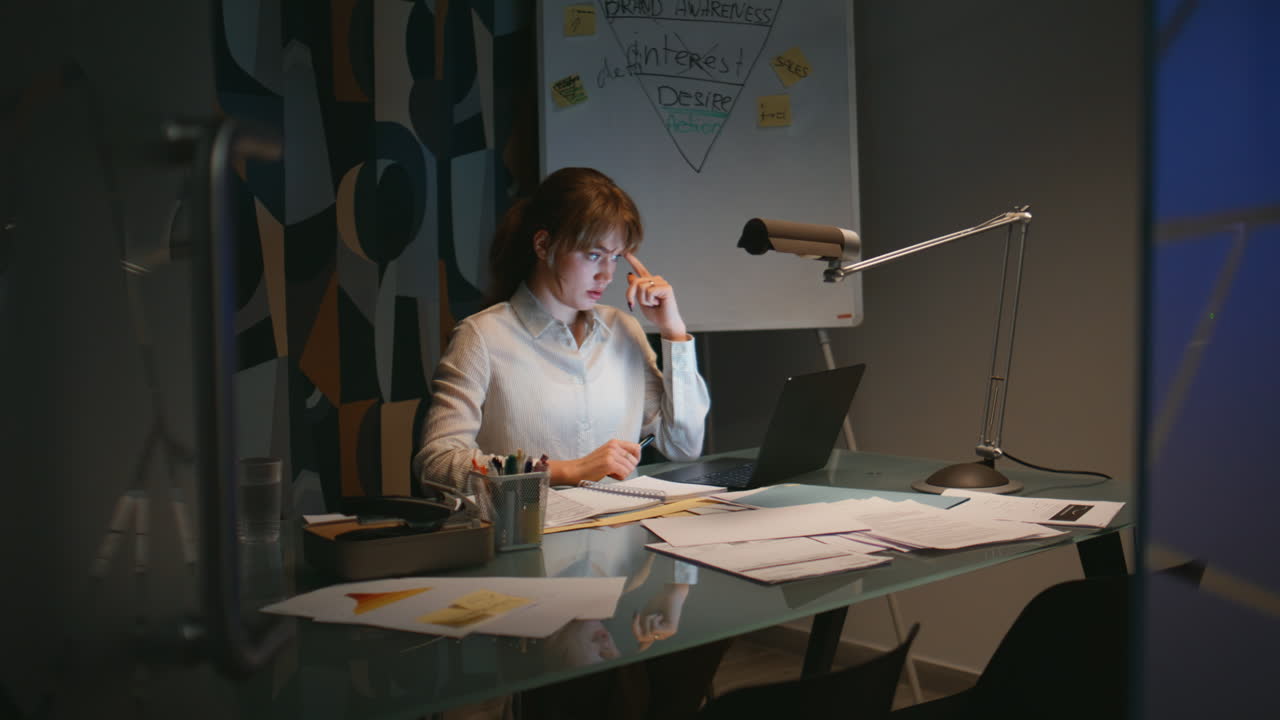 Evening manager videocalling online conference computer in dark interior closeup