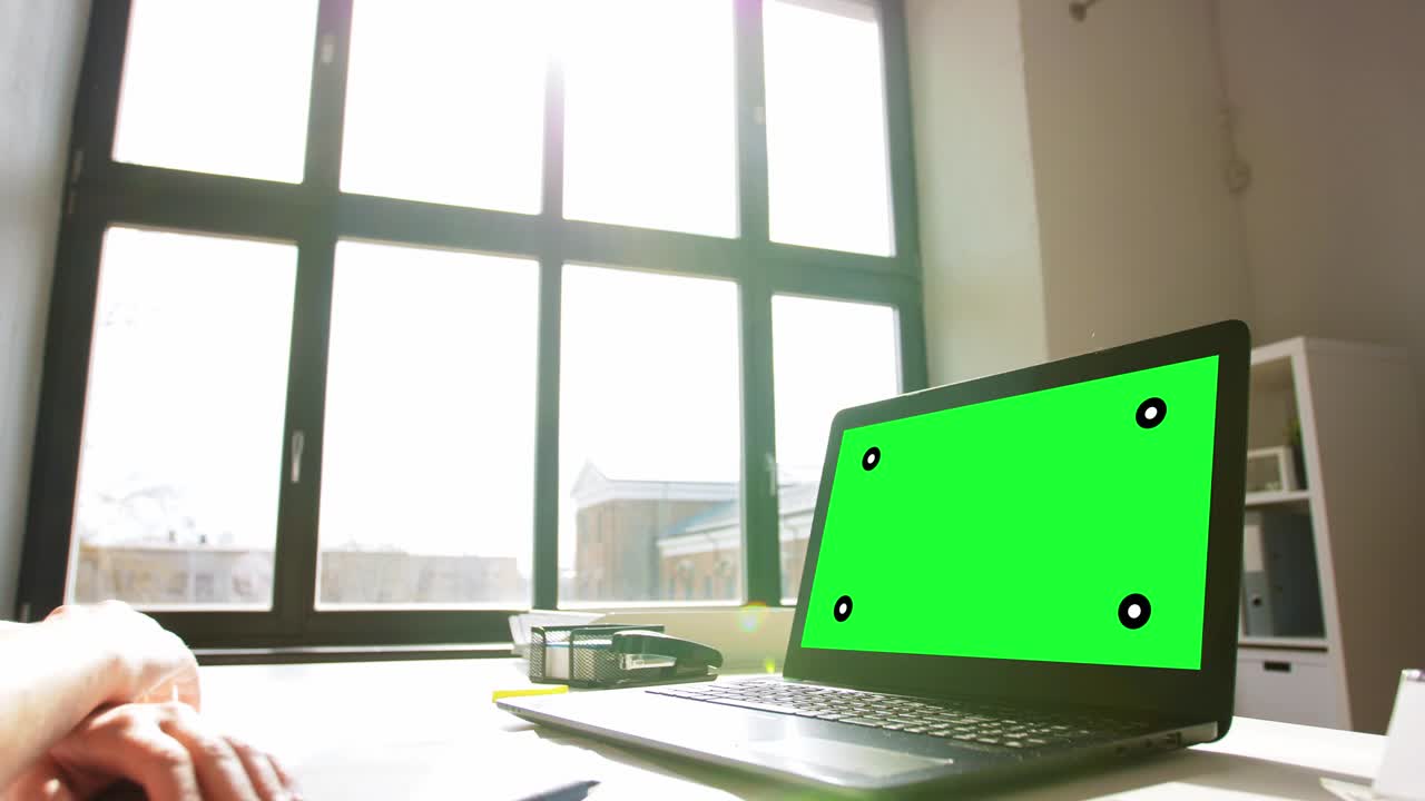 woman with laptop having video call at home office