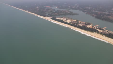 a beach is shown in an aerial shot with a river in the background